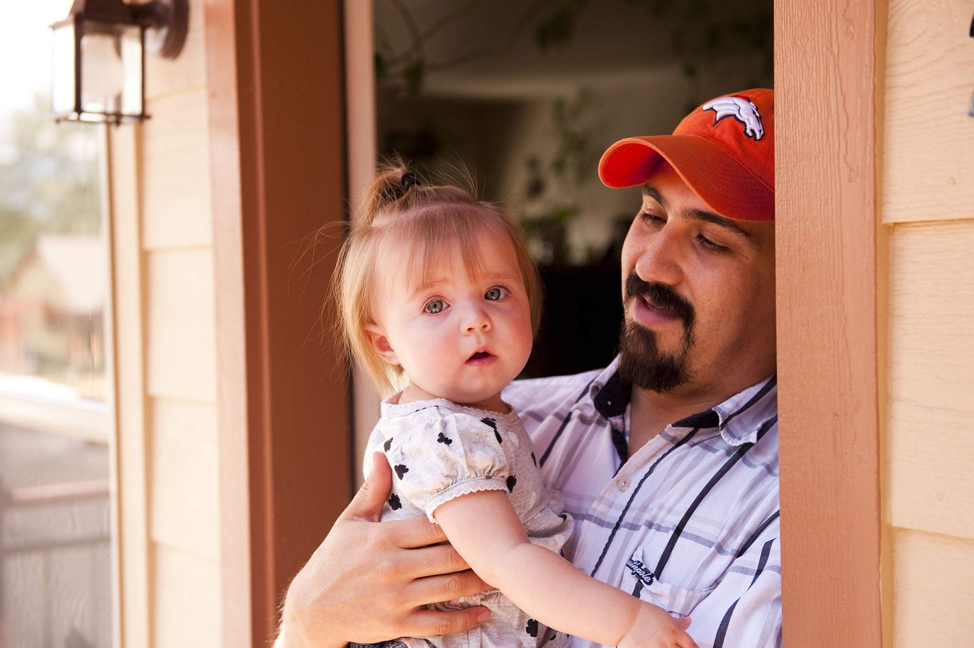 photo of resident with child at unit entry in villas on the bluff - delta colorado