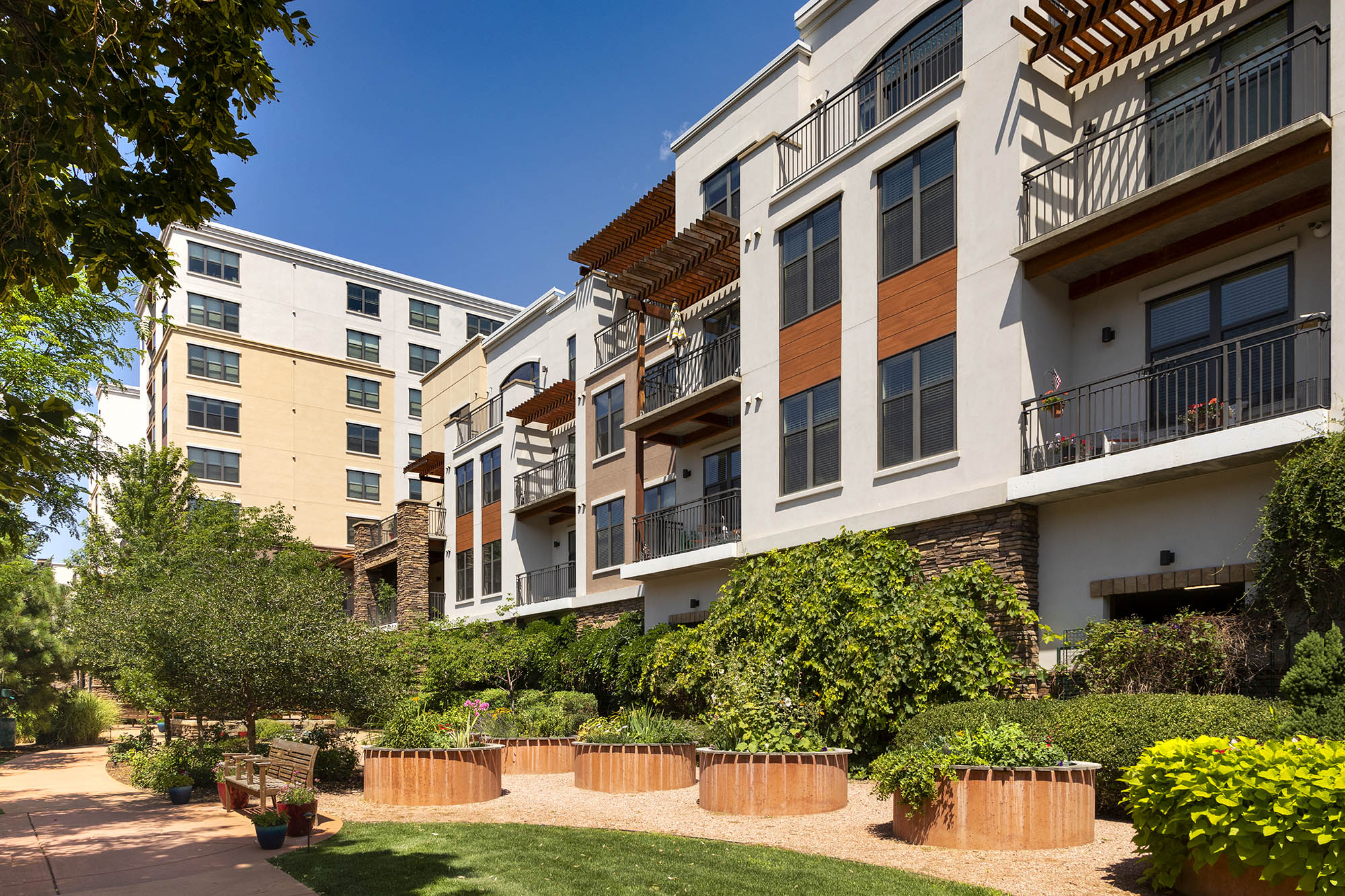 Exterior facade of Carillon senior housing in boulder with garden in foreground