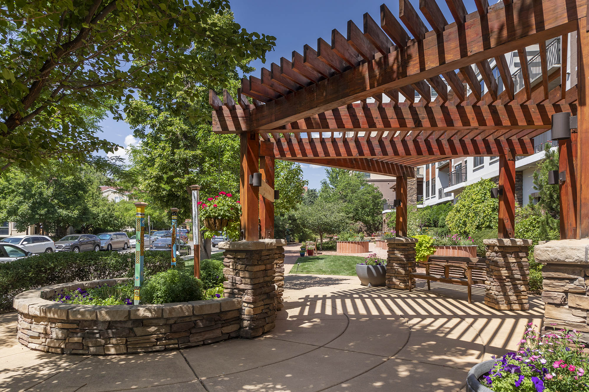 wood and stone Pergola shade structure in garden at Carillon in Boulder