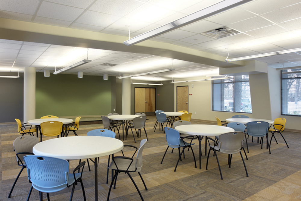 Community room interiro space with round tables and chairs