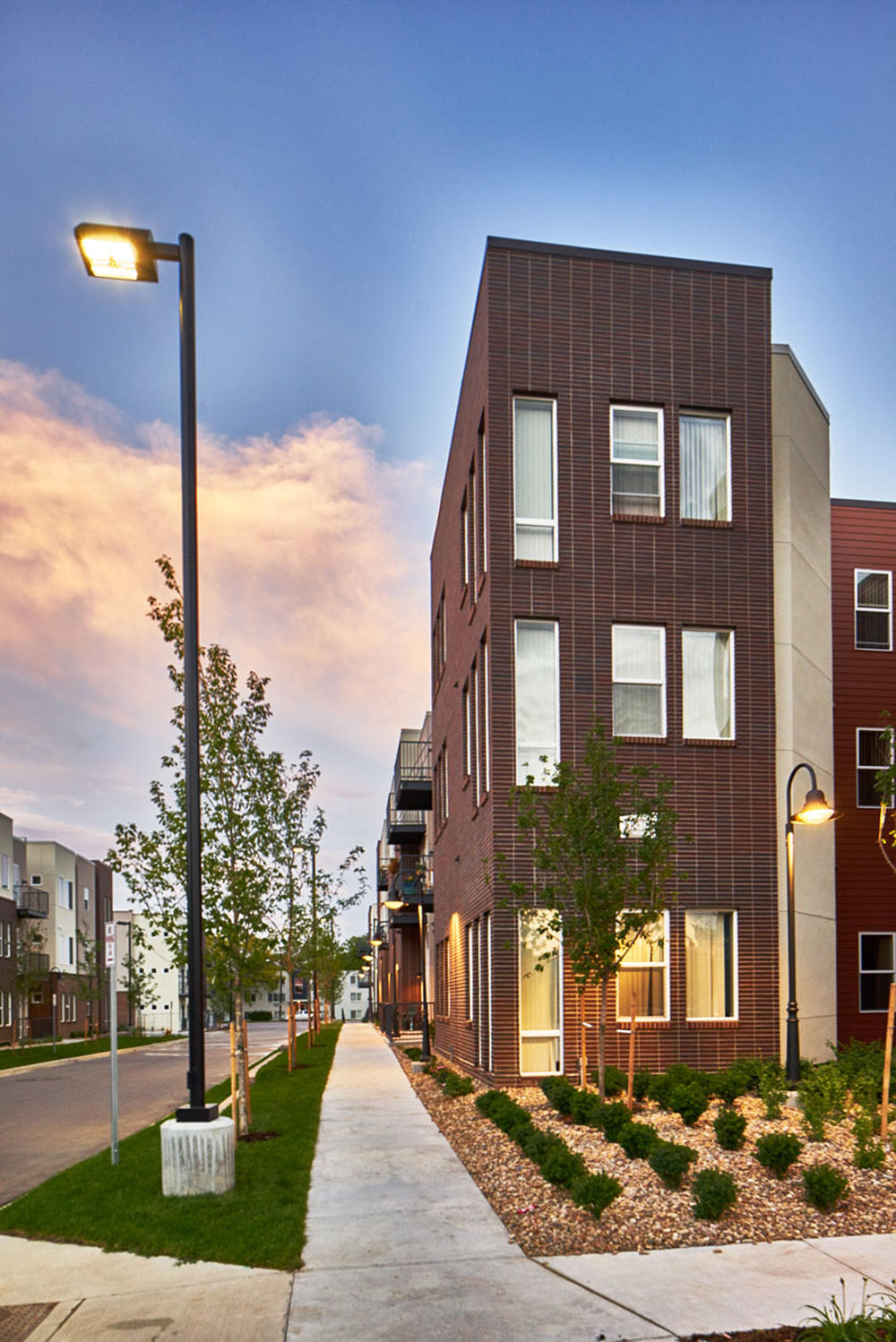 corner of lumien fitzsimmons 3 storey building with plantingand site lighting