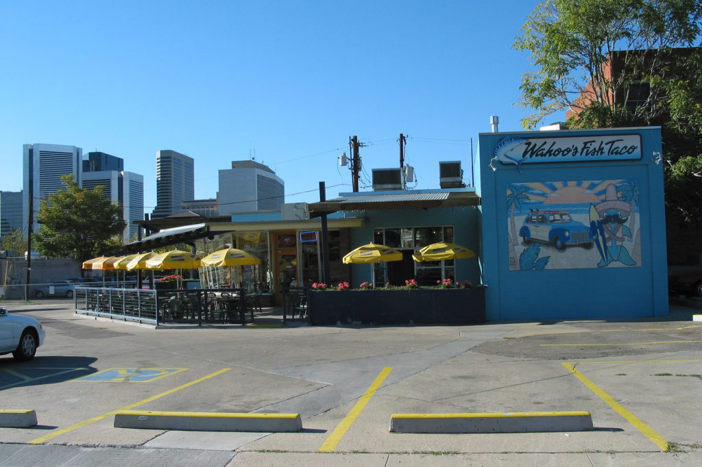 Facade of Wahoo's restaurant on 20th Avenue with downtown in background