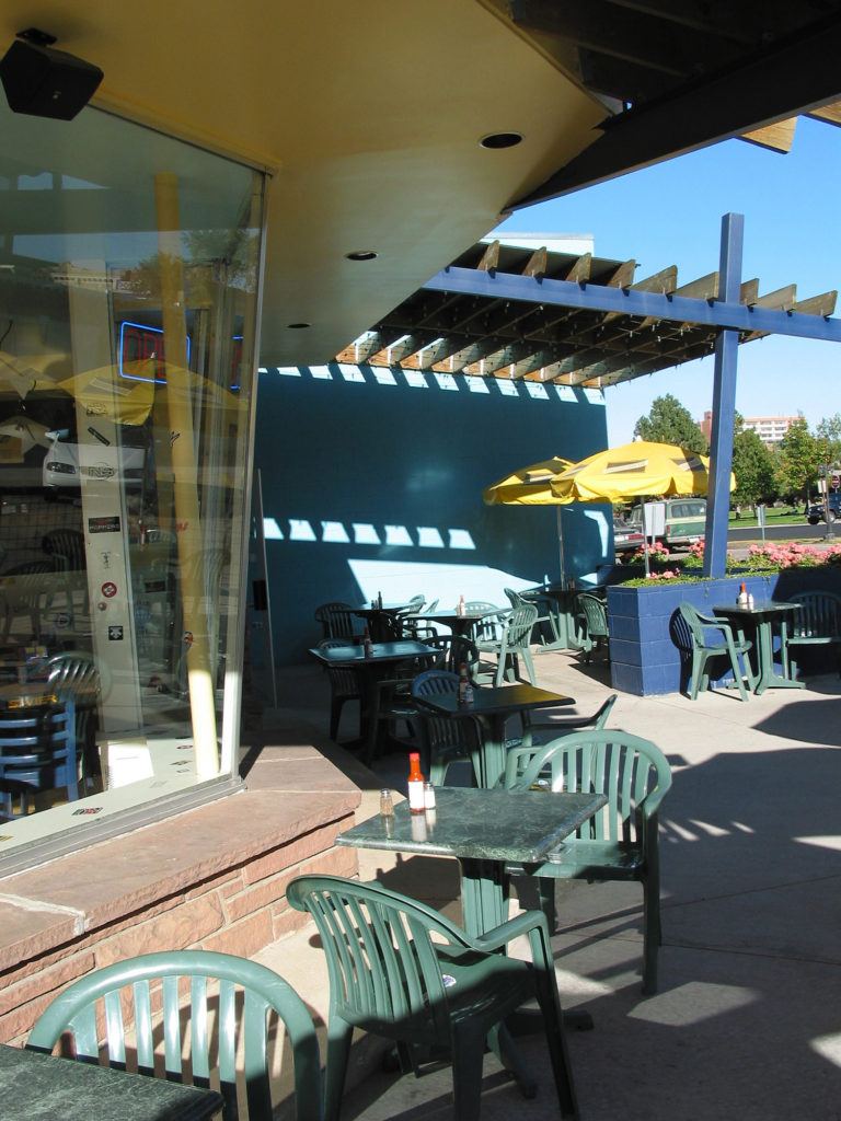 Image of pergola, umbrellas and Patio tables at Wahoo's Restaurant on 20th Avenue