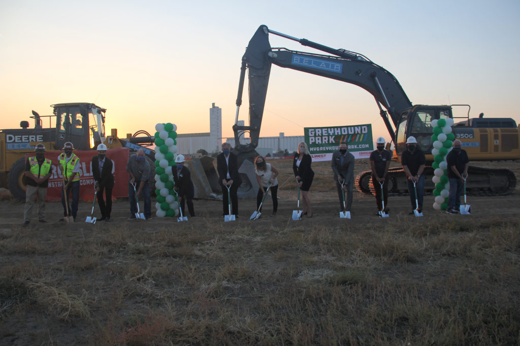 ground breaking photo for greyhound apartmetns people holding shovels, balloon towers and construciton equipment
