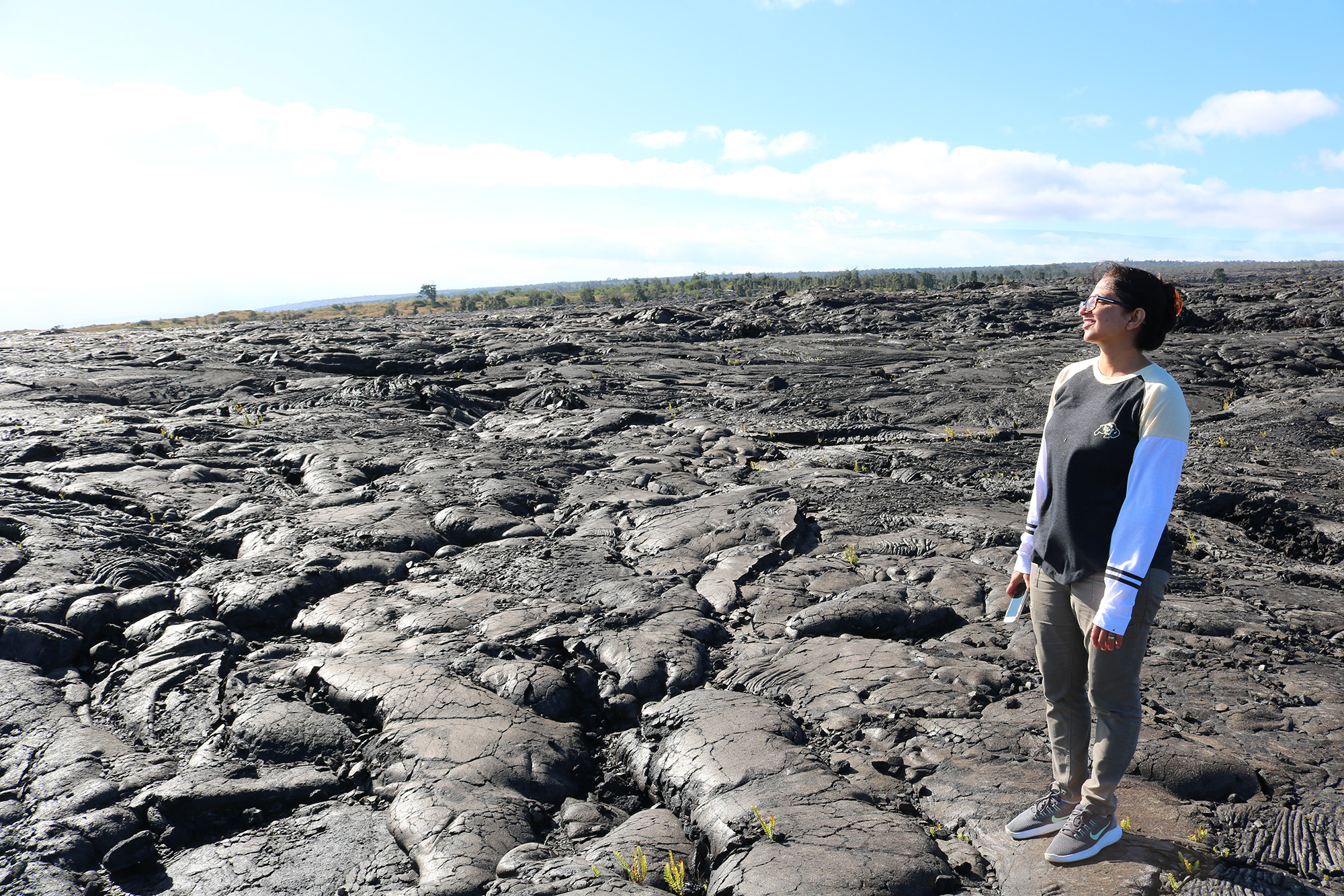 Photo of jeru standing in lava fields in hawaii