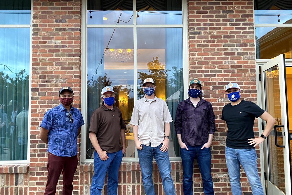 Team members in mask after receiving the Eagle Award for Vida